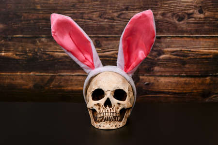 Skull with pink ears of the Easter bunny.