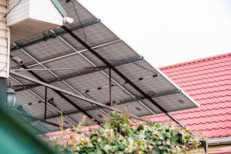 A canopy in the yard made of solar panels in a private house as an autonomous ecological electricity.の写真素材