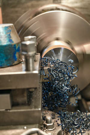 End trimming with a cutter on a lathe. Metal shavings on the machine.の写真素材