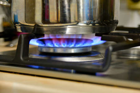 Heating water in a kettle on a gas stove at home.
