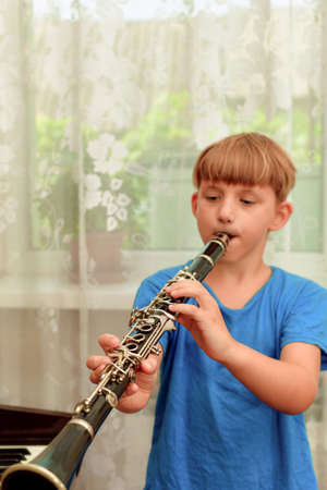 The boy plays the clarinet at a music school.の写真素材