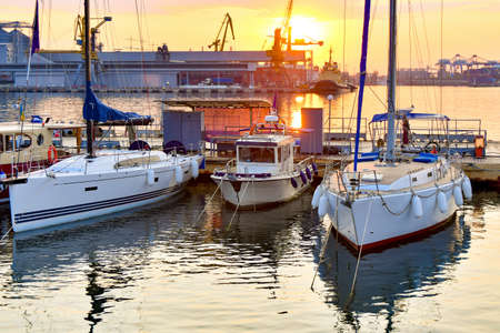 Anchorage with sailing yachts on the sea in the yacht club against the backdrop of the evening sky...