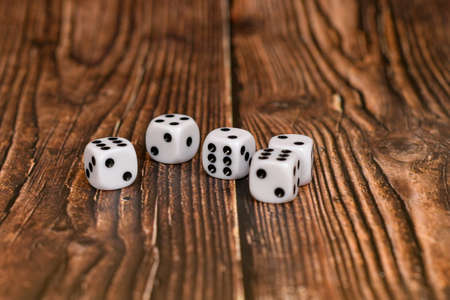 White dice on a wooden texture. Casino and gambling concept.の写真素材