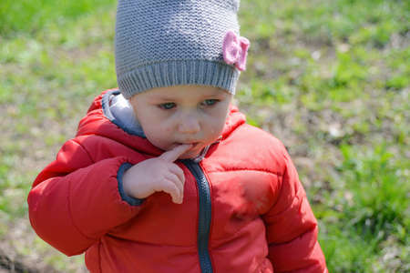 Little girl crying on the street walking in the park.の写真素材
