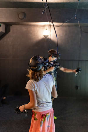 A girl with a guy at the VR games competition. Online games in cyber space.