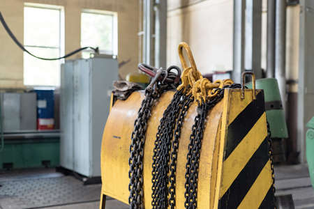 Yellow storage rack for chain slings for lifting loads on a crane.の写真素材