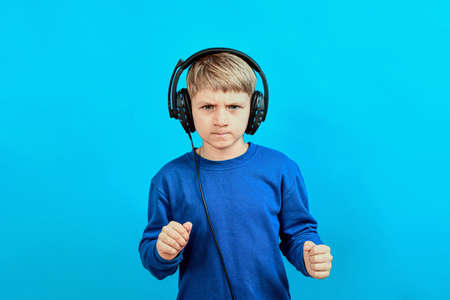 A boy with big headphones listens to music.の写真素材