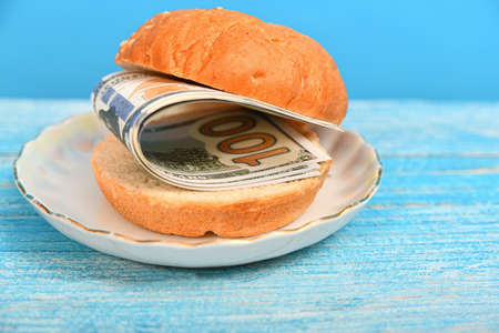 American dollars between pieces of bread on a platter.の写真素材
