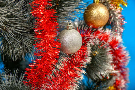 Plastic balls hang from the Christmas tree creating a great festive atmosphere.