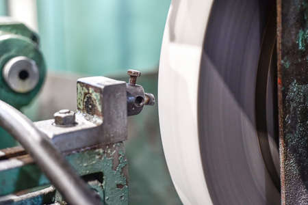 Cleaning the surface of the grinding wheel from adhesion of metal residues when grinding the surface of the part.の写真素材