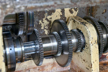 Gears and indexing discs inside the gearbox of a metal cutting machine.