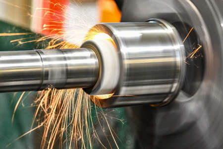 Sparks from the grinding wheel during internal grinding on a cylindrical grinding machine.