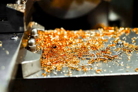 Bronze shavings on a lathe after making a non-ferrous metal part.