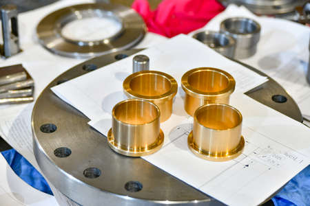 Bronze bushings on technical drawings in a repair shop.の写真素材