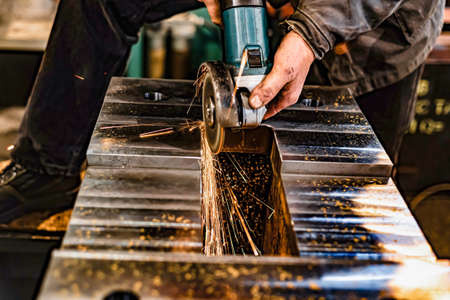Grinding burrs and metal with an angle grinder with sparks