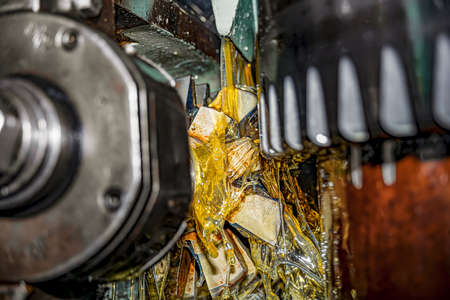 Making gears on a gear cutting machine. Machine oil cools the cutting process of the gear wheel with...