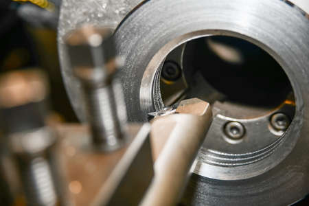 Cutting an internal thread on a slotted nut with a special mechanical cutter on a lathe.