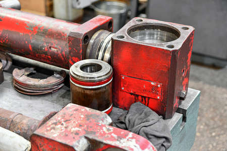 Dismantled hydraulic pumps from various units being repaired in a locksmith shop.