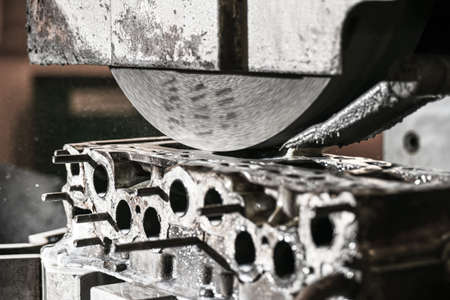 Grinding the cylinder head of the engine on a surface grinder.の写真素材