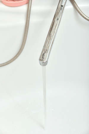 Clean water flows from the tap in the bathroom.