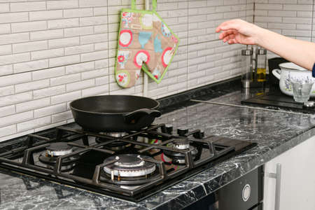 Empty frying pan on the gas stove in the kitchen.の写真素材