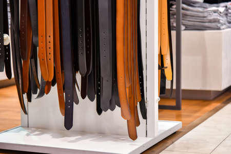 Leather men's belts in black and brown for sale in the mall.