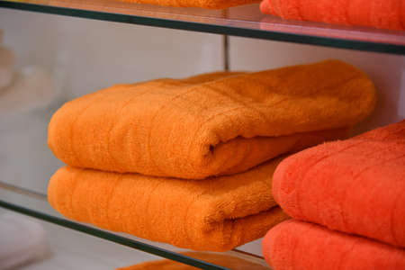 Colored towels lie on the counter of a shop for sale in a mall.の写真素材