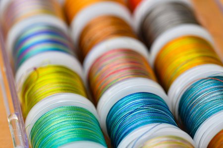 Colored threads for sewing in skeins lie together.