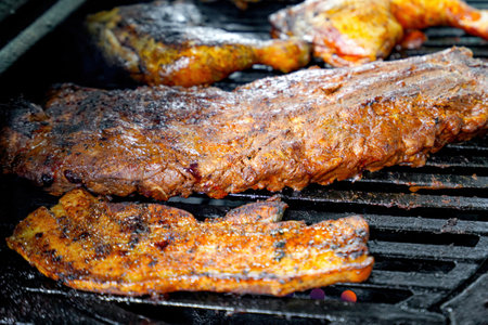 Baked and fried meat cut into pieces is cooked over a fire on a gas grill.の写真素材