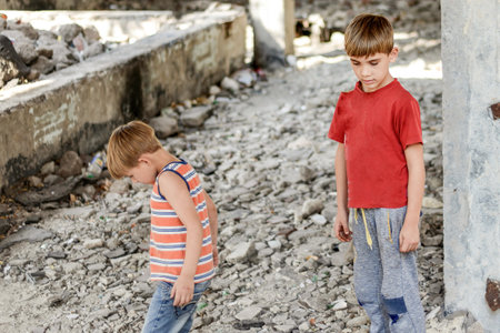 Poor and dirty street children living on an abandoned construction site. a concept of the life of street children orphans.の写真素材