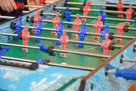 Two excited boys play table football.