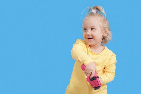 A joystick from a game console in the hands of a child, cheerful emotions in a little girl.の写真素材