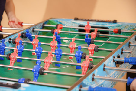 Children play table football.