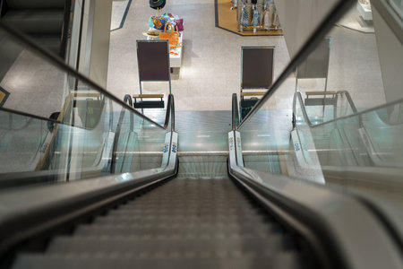 Empty escalator in a closed shopping center without people.