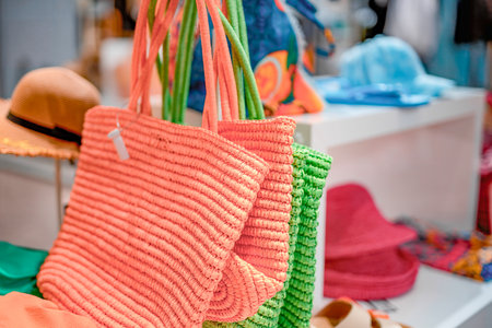 Summer beach woven women's fashion bags of different colors on sale in the shopping center.の写真素材