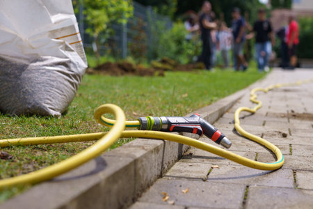 Watering hose with tap on the territory for landscaping.の写真素材