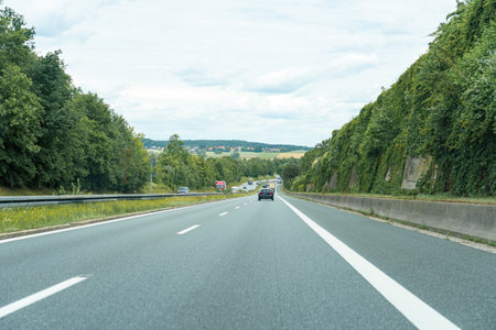 High-speed road with moving cars. Autobahn and cars.の写真素材