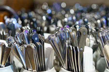 Clean spoons, forks and knives in the kitchen in a cafe. Cutlery in a restaurant.の写真素材
