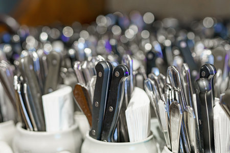 Clean spoons, forks and knives in the kitchen in a cafe. Cutlery in a restaurant.の写真素材