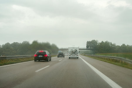 A motorhome on the highway moves along the road in the rain.の写真素材