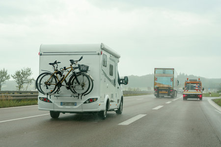 A motorhome on the motorway transports bicycles in the back of the car.の写真素材