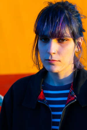 Alternative girl in yellow background sadの写真素材