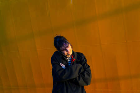 Alternative girl in yellow background talking smart phone without hands