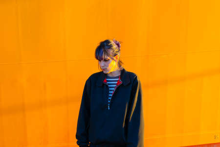Alternative girl in yellow background sad with a bubblegum