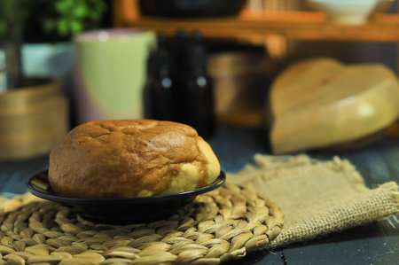 coffee-flavored bread served on a wooden plate with bokeh backgroundの写真素材