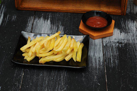 French fries on a black plateの写真素材