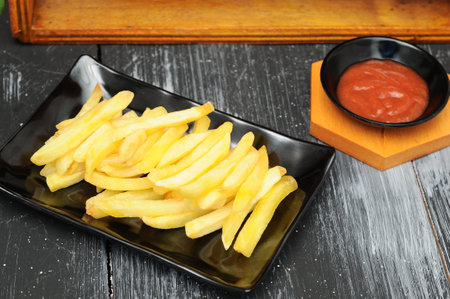 French fries on a black plateの写真素材