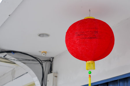 red lantern hung at white roof