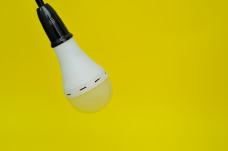 LED light bulb isolated on yellow background with copy space for text.の写真素材