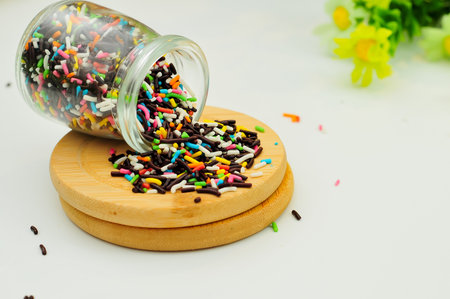 chocolate grains in a jar on a white base and bokeh backgroundの写真素材